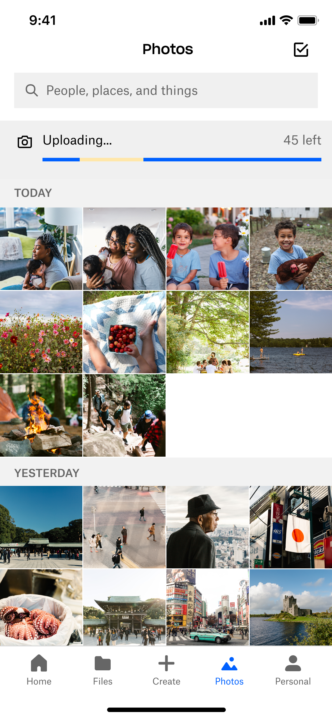 Previous Dropbox Photos tab with a sync banner and gray date section headers.
